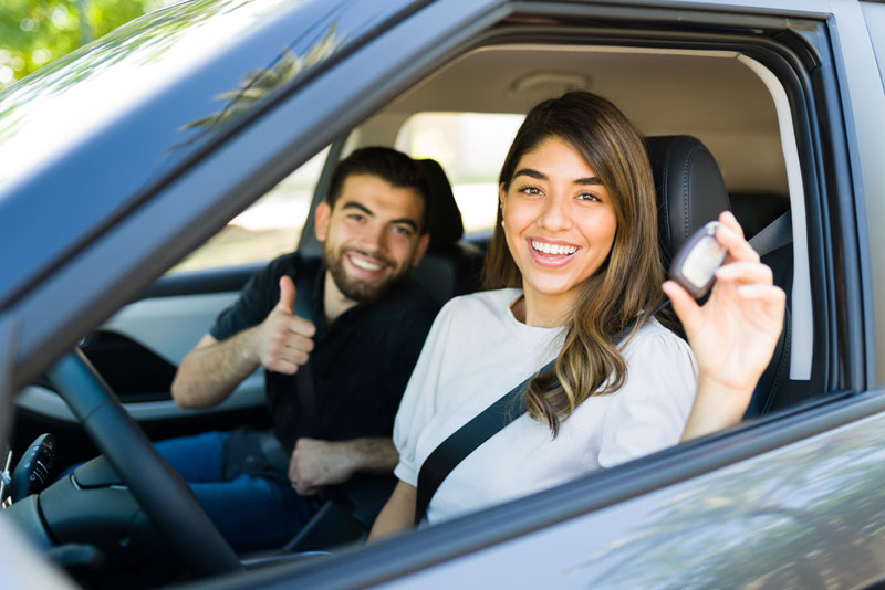 Customers driving home with a financed vehicle